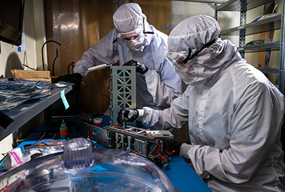 Students working on a satellite. Links to Donor-Advised Funds