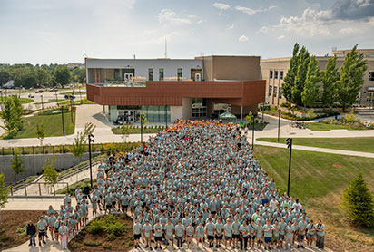 Students gathered in front of a building. Links to Gifts of Real Estate